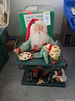 Full view of animated Santa figure on workbench with box in background