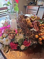 Overall view showing wreath, glass candle holder, assorted faux florals and berries