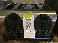 Front view of BeauMark stainless steel 4-slice toaster showing dual control panels and slots