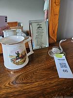 All three items displayed: tankard, plaque, swan dish