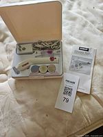 Open case showing nail file, adapter, attachments, manual