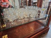 Wide view of cabinet shelf showing majority of Cornflower stemware pieces