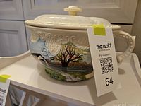 Tureen profile showing hand-painted scene, lid, handle and relief border