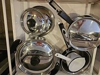 Close-up of stainless steel lids and pot bodies