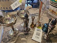 Group shot of all seven silver-plated and brass pieces