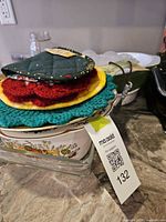 Stack showing potholders, casserole, glass baking dish