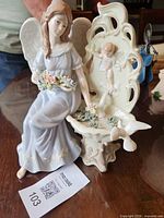 Full view of porcelain angel and cherub figurine on table