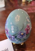 Hand-painted floral egg with gold-tone stand