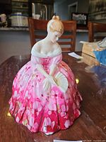 Front three-quarter view of figurine showing gown, pose and colours
