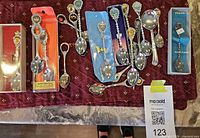 Overall view of approximately 18 souvenir spoons, boxed and loose