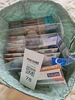 Multiple pantyhose packs and brown leather insoles inside container