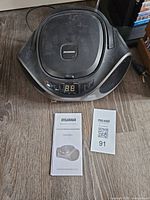 Top view of Sylvania boombox with manual