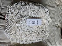 Stack of white/cream crocheted doilies showing lace pattern