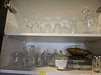 Cabinet shelf with wine glasses, decanter, assorted crystal pieces