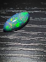 Top view of marquise black opal showing multicolour play