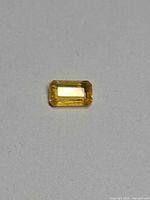 Front view of rectangular lemon yellow sapphire