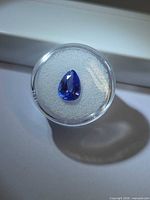 Pear-cut tanzanite in gem jar, top view showing color and clarity