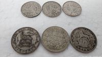 All six coins arranged showing reverse designs