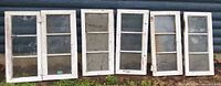 Six rectangular three-pane windows lined against wall