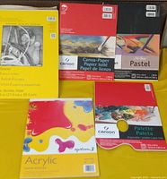All five paper pads arranged on yellow background