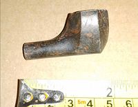 Side profile of Bakelite pipe bowl with measuring tape for scale
