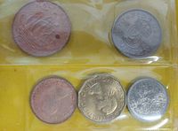 Five coins in plastic sleeve showing reverses: halfpenny Golden Hind, shilling crowned shield, penny, threepence, sixpence