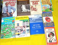 All nine book covers laid out on yellow background
