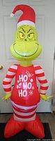 Front view of illuminated 5 ft Grinch inflatable