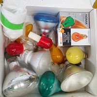 Top view of box showing assorted coloured incandescent bulbs and reflector flood bulbs
