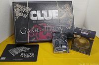 Lot overview showing Clue game box, mouse pad, Dorbz figure, Mega Construx figure