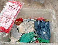 Bin with sealed Ansell Sol-Vex package, blue Mitrex gloves, green rubber gloves, assorted cotton gloves