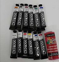 Overview of 11 Golden OPEN paint tubes and one DecoArt bottle