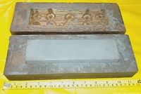 Full view of sharpening stone in wooden base with cover and measuring tape showing size