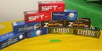 Front view of stacked golf ball sleeves showing brand names and colours