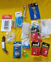 Full lot view showing all packaged and loose door stoppers on yellow background
