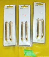 Three blister packs of two brass drawer handles each