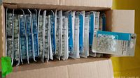 Open carton showing multiple blister packs of cable clips