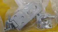 Individual packaged hasp showing hasp, swivel staple and screws