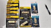 Multiple Stanley hasp and hook packages, Stanley hasp packages, and National Hardware hinge packages displayed