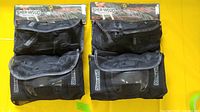 Two sealed Sher-Wood protective gear sets in mesh bags