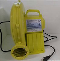 Full view of yellow air blower with handle and outlet