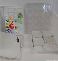 all pieces of PaintKeeper palette system including large palette, clear round-cup palette, multiple trays