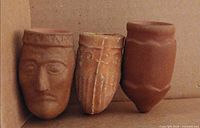 Three clay pipe bowls side by side showing designs