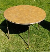 Full view of round folding table outdoors