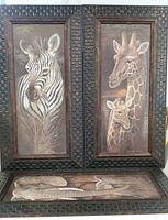 Zebra and giraffe framed prints side by side with elephant print placed below showing overall frames and art