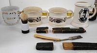 overview of four mugs, razor, brush and cases