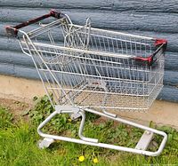 Full view of metal shopping cart on grass