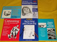 Front covers of all five art instruction books laid out