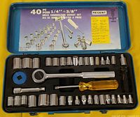 Open case showing ratchet, spinner handle, extension bar, adaptor, and sockets