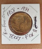 Reverse showing Terry Fox running design, year and denomination visible in uncirculated condition within 2x2 flip